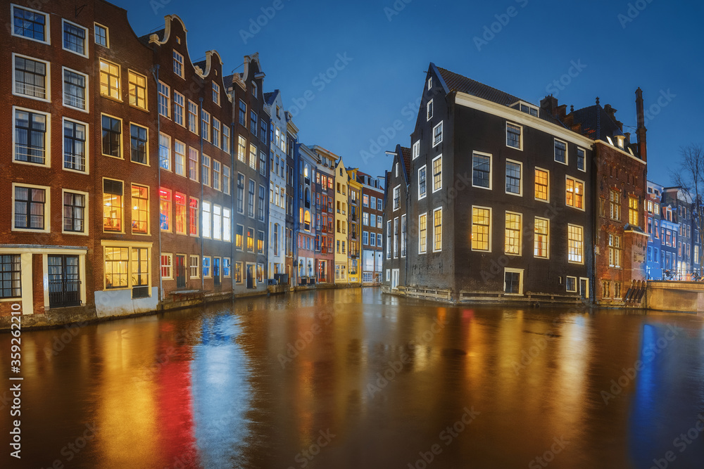 Amsterdam city canal old town, Netherlands. Beautiful iconic view illuminated at night