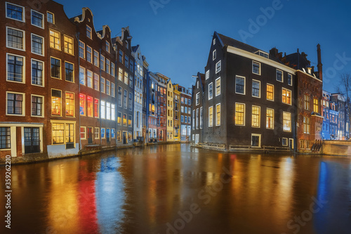 Amsterdam city canal old town, Netherlands. Beautiful iconic view illuminated at night