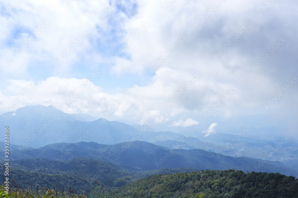 Beautiful mountain landscape, with mountain peaks covered with forest and a cloudy sky. Chiang Mai, Thailand