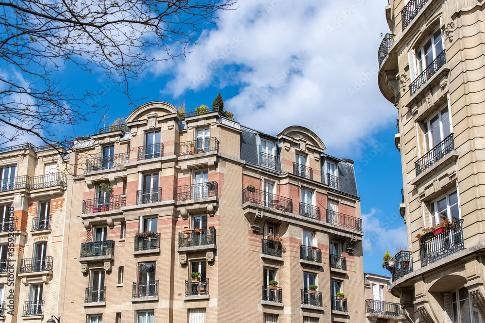 Paris, beautiful building in Montmartre, with typical orange brick on the facade
