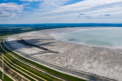 Industrial mine, abstract sendimentation tank of copper mine , turquoise water like river delta. Huge sewage treatment tank in Poland photo