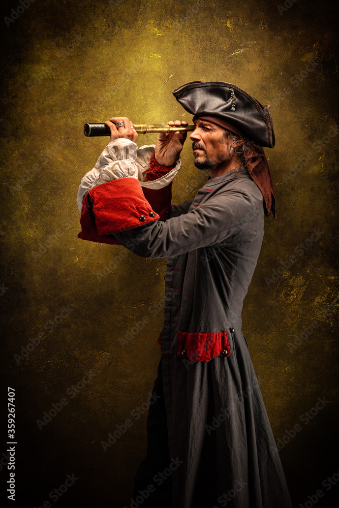 Portrait of a pirate, holding a spotting scope in his hands - obrazy, fototapety, plakaty 