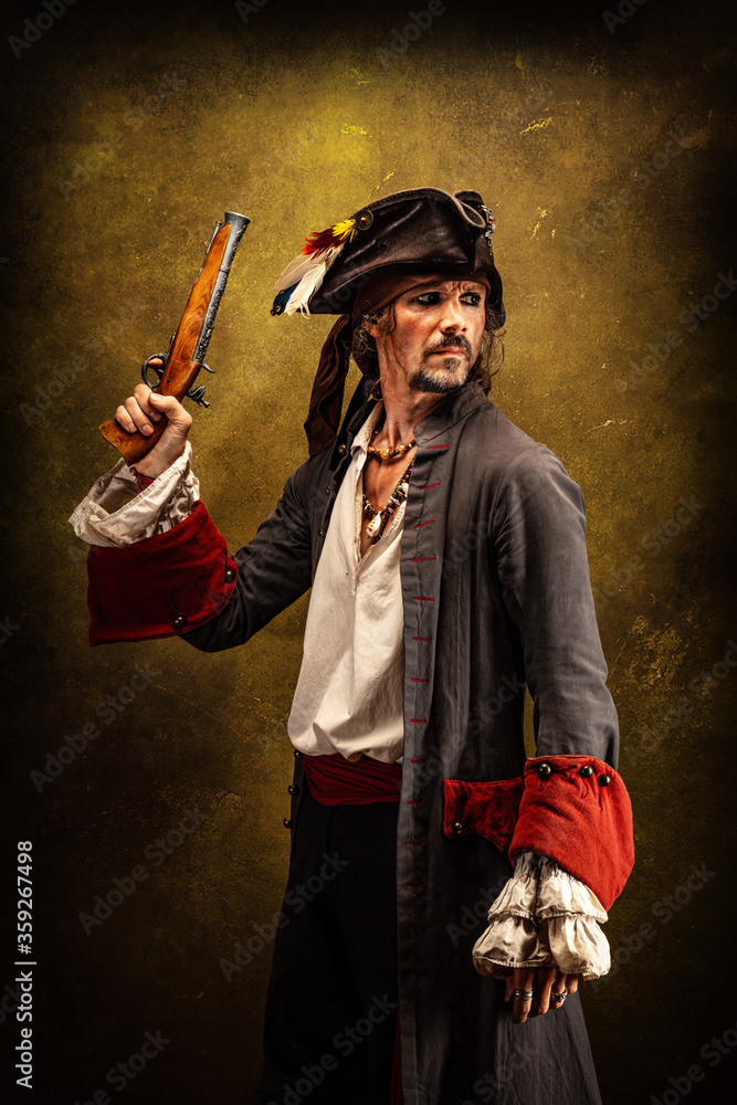 Naklejka premium Portrait of a pirate, holding a musket gun in his hand