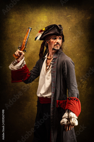 Portrait of a pirate, holding a musket gun in his hand