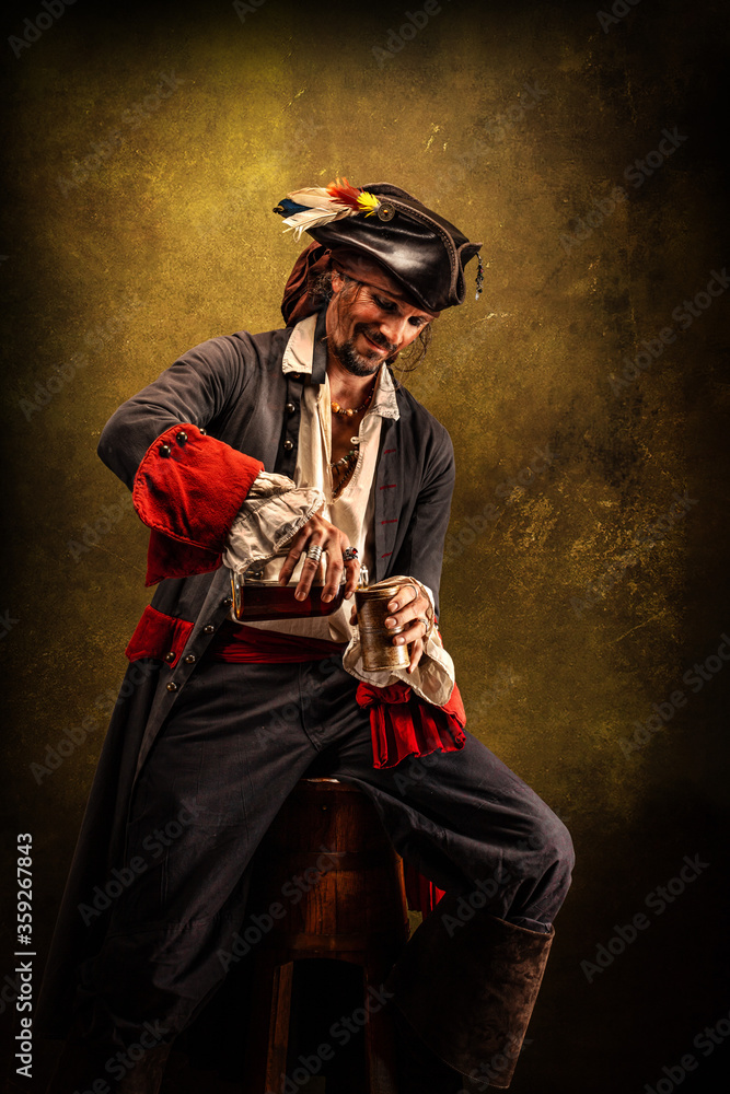 Fototapeta premium Portrait of a pirate in profile, drinking rum sitting in a tavern