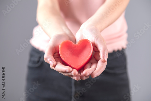 woman hand red heart