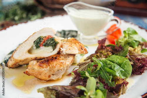 Cooked tender chicken breast with spinach