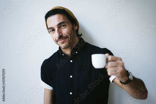 Portrait of a handsome guy with cup of coffee