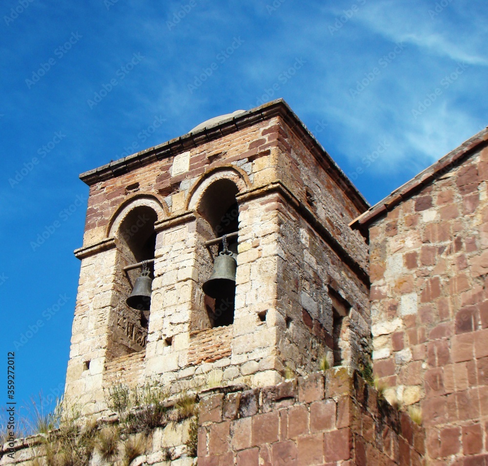 Bell tower with representation of the sun god 	of Santa Barbara church (andean baroque)- Ilave (Lake Titicaca, Peru)