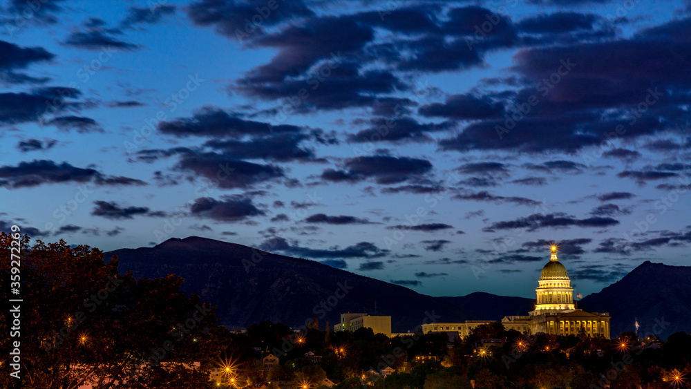 State of Utah capital building at night with clouds in a dark blue sky