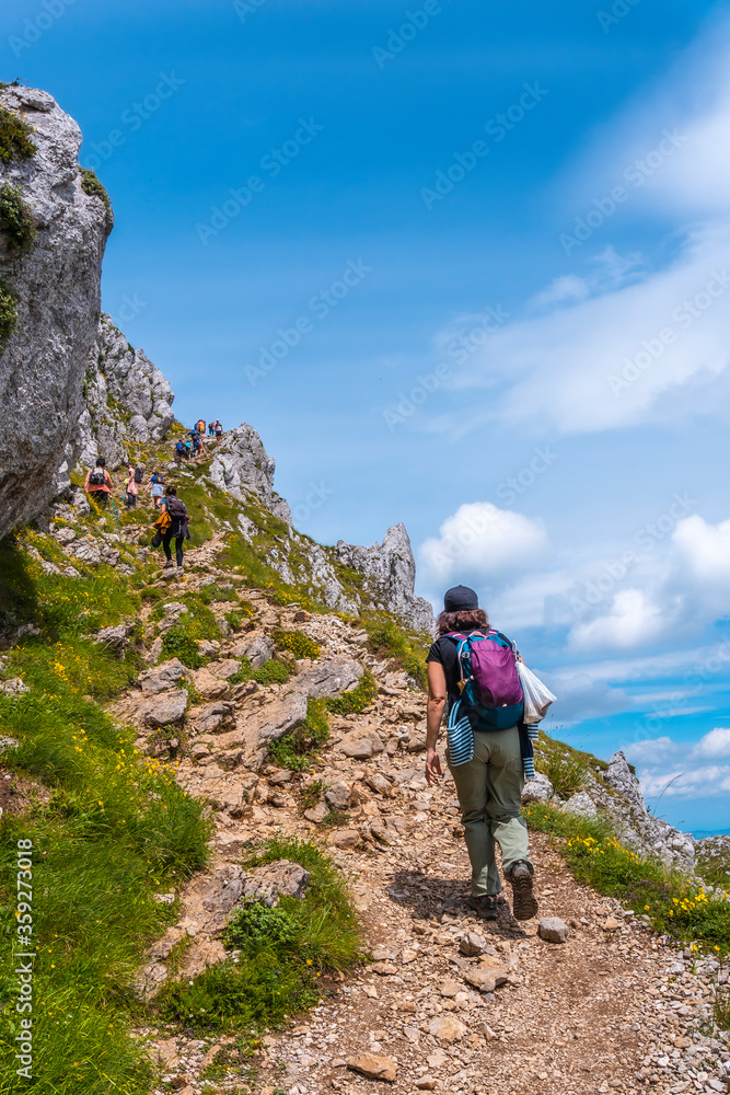 Mount Aizkorri 1523 meters, the highest in Guipuzcoa. Basque Country. A young girl with a backpack reaching the top. Ascent through San Adrian and return through the Oltza fields