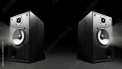 Two sound speakers with free space between them on black background.