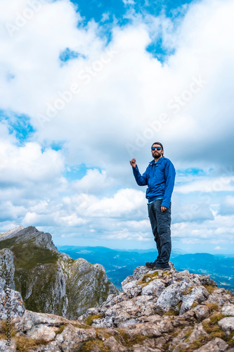 Mount Aizkorri 1523 meters, the highest in Guipúzcoa. Basque Country. Ascent through San Adrián and return through the Oltza fields. A young man in blue looking at the views from the top