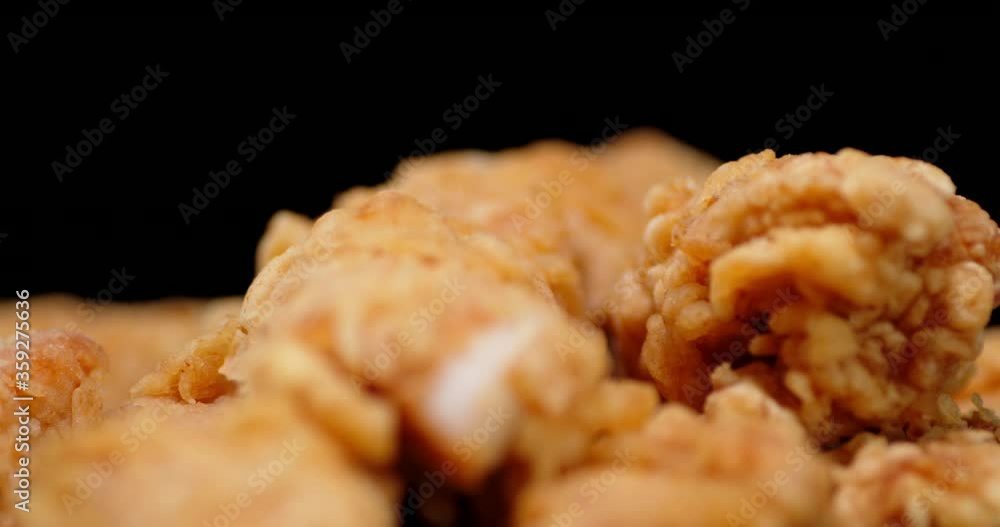 A pile of chicken strips on the table slowly rotates. A pile of chicken strips on the table slowly rotates.