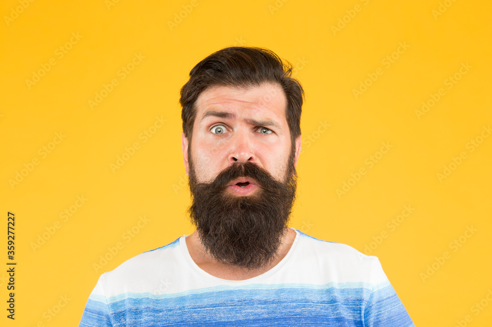 Hair care and skincare. amazed brutal bearded man on yellow backdrop. handsome confident man has perfect hairdo. male facial care. portrait of brutal bearded man. serious stylish man with moustache Hair care and skincare. amazed brutal bearded man on yellow backdrop. handsome confident man has perfect hairdo. male facial care. portrait of brutal bearded man. serious stylish man with moustache