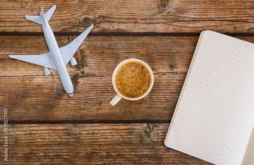 Travel planning airplane paper note in coffee cup