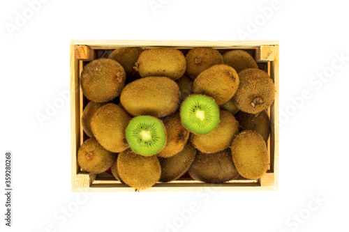 Kiwi fruit in a wooden case isolated on a white background. Organically produced kiwis in a wooden case.