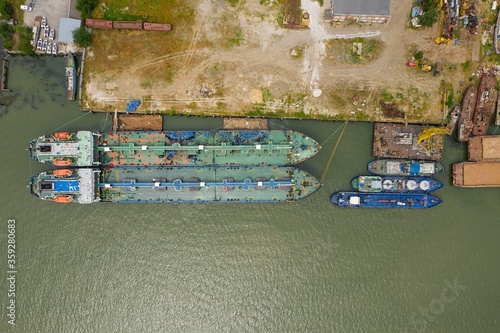 Cargo ship moored at the pier at the port. Aerial view. photo