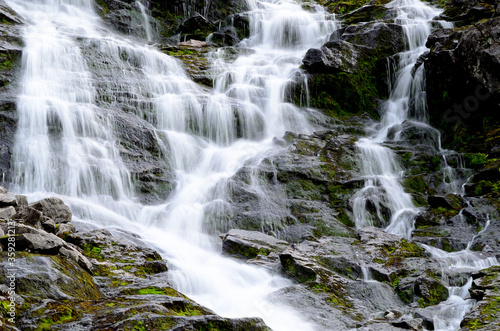 clean fresh water stream running down mountain side in summer landscape