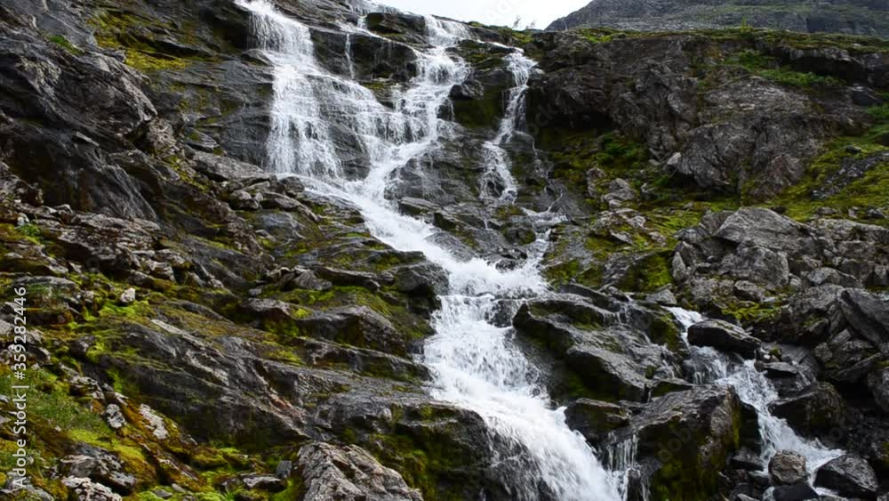 big waterfall on the mountain of Kaperdalen on the island of Senja, Northern Norway big waterfall on the mountain of Kaperdalen on the island of Senja, Northern Norway