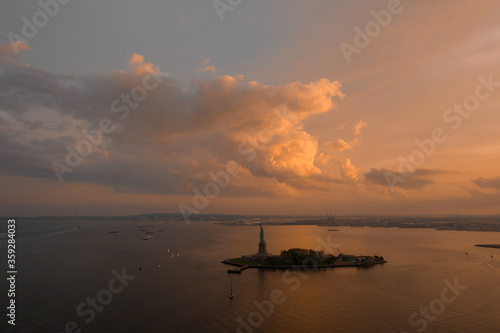 Aerial View of Statue of Liberty at sunset 