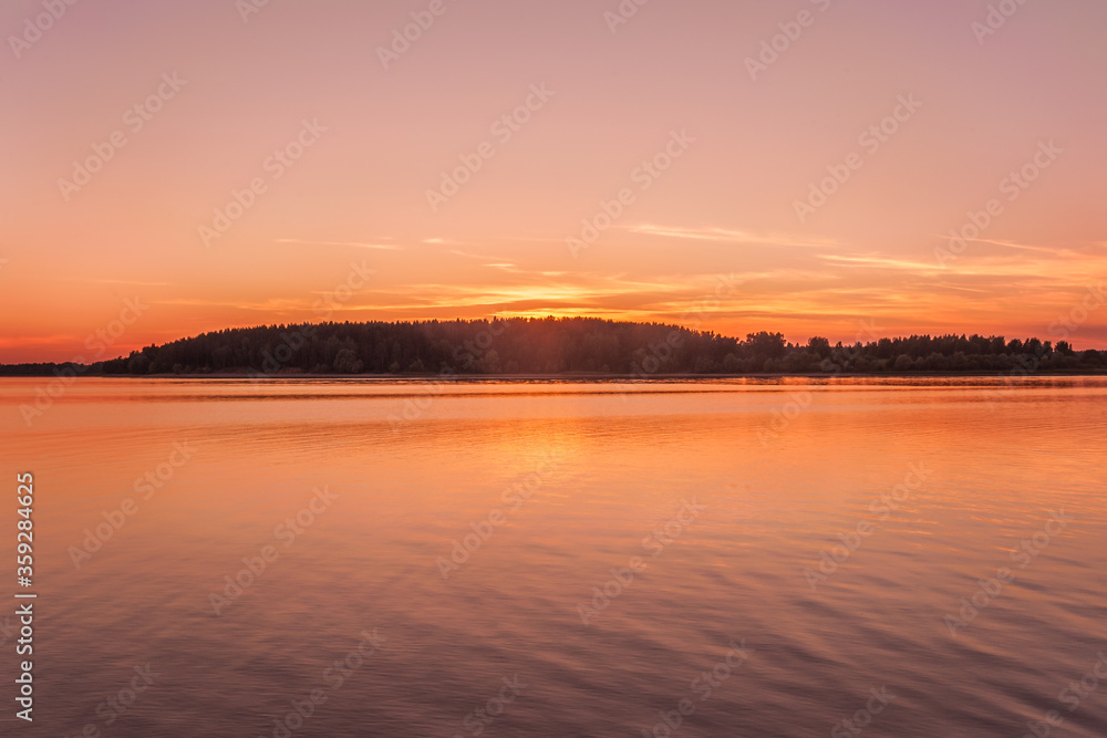 landscape sunset on the forest lake golden hour
