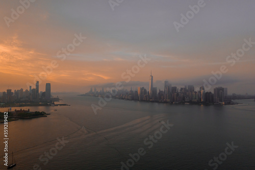 Aerial view of New York City skyline at sunset with both midtown and downtown Manhattan from Hudson river 