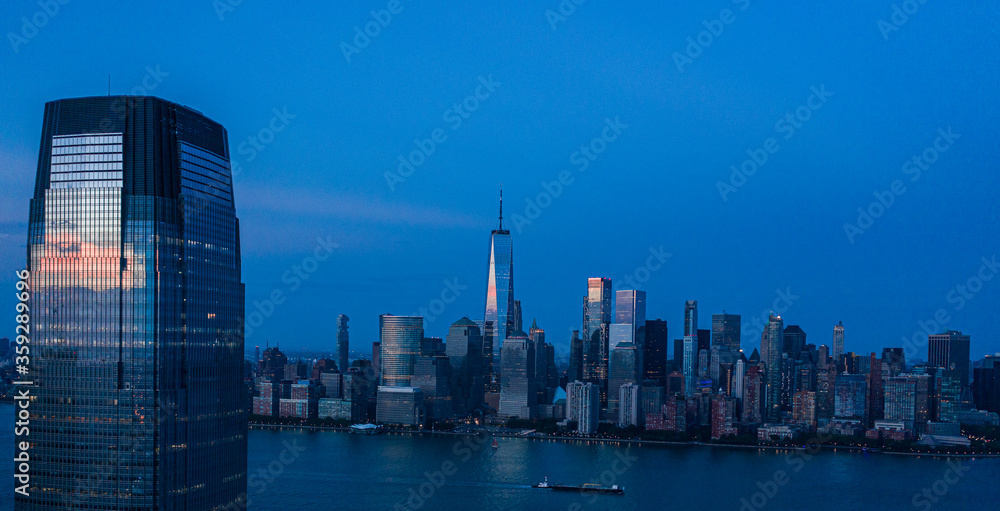 Aerial view of lower Manhattan at dusk from Hudson river. 