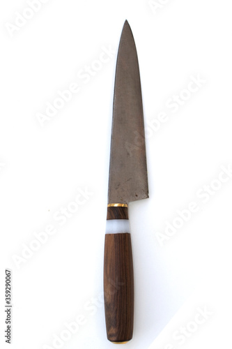 Old vintage homemade kitchen or household knife with a wooden handle and a blade from a saw blade isolated on a white background