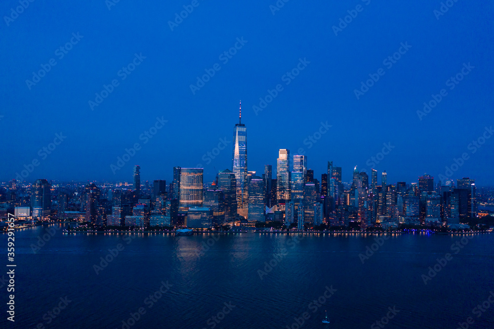Aerial view of lower Manhattan at dusk from Hudson river. 