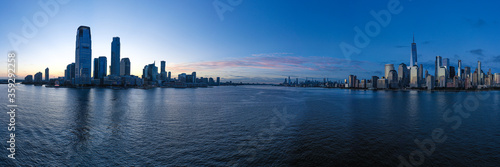 Aerial panorama of New York City skyline with both Jersey City and downtown Manhattan from Hudson River 