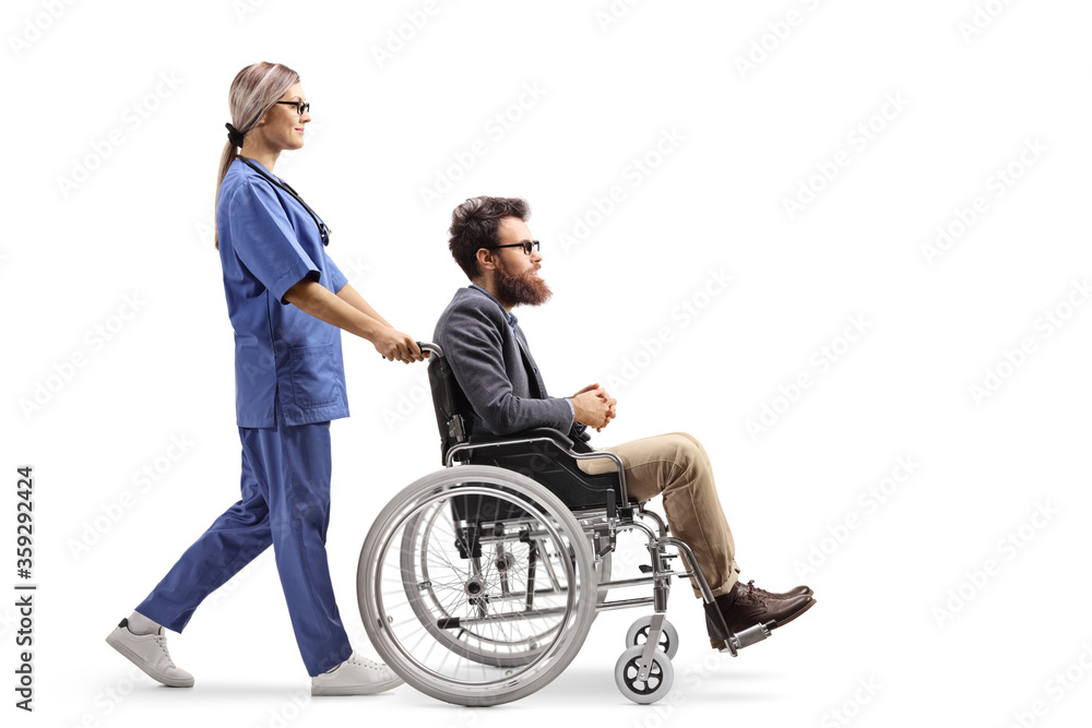 Female nurse pushing a disabled man in a wheelchair Female nurse pushing a disabled man in a wheelchair