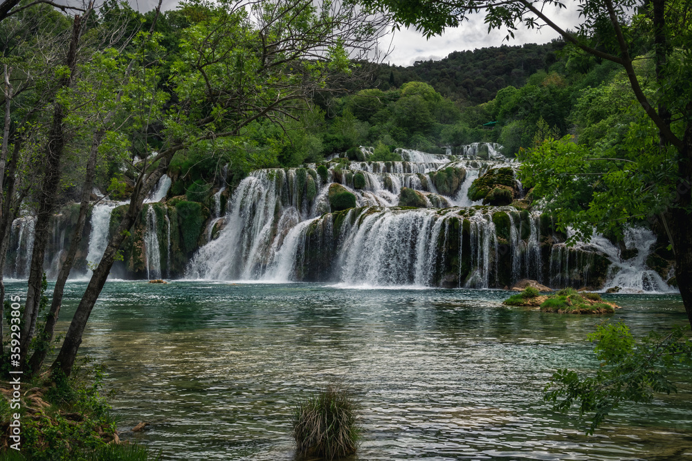 Beautiful Krka waterfalls with a lush green trees and turquoise water. Croatia, 28th April 2015. Beautiful Krka waterfalls with a lush green trees and turquoise water. Croatia, 28th April 2015.