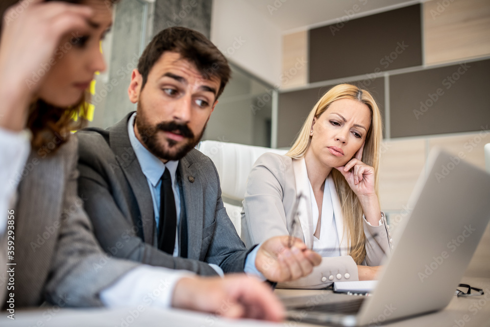 Business people discussing while being really disappointed Business people discussing while being really disappointed