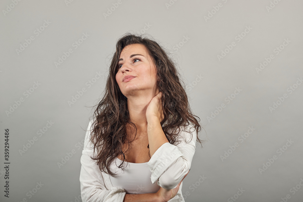 Tilting face to side, gently touching neck with a hand, beauty redefined, good looking, keeps fingers on head, touches soft skin, people and health, profile of satisfied. Young attractive woman Tilting face to side, gently touching neck with a hand, beauty redefined, good looking, keeps fingers on head, touches soft skin, people and health, profile of satisfied. Young attractive woman