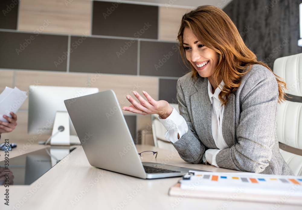 Businesswoman having an online conference with her colleagues Businesswoman having an online conference with her colleagues