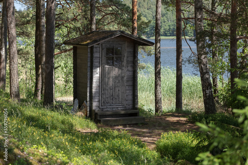 Fototapeta Naklejka Na Ścianę i Meble -  Public toilet (wooden building) in the forest. Finland.
