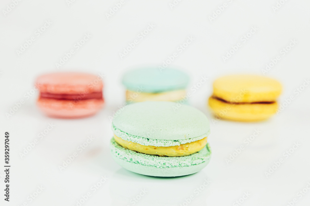 Sweet almond colorful pastel pink blue yellow green macaron or macaroon dessert cake isolated on white background. French sweet cookie. Minimal food bakery concept Copy space Sweet almond colorful pastel pink blue yellow green macaron or macaroon dessert cake isolated on white background. French sweet cookie. Minimal food bakery concept Copy space