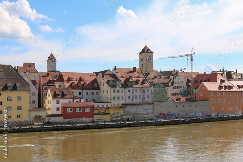 Regensburg, Germany - June 21 2020: Colorful houses along the Danube river in Regensburg Germany on a lovely summer day.