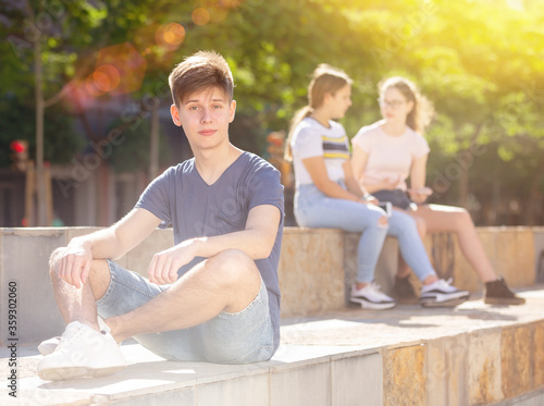 Confident teen boy spending time outdoors in summer