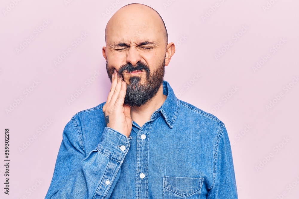 Young handsome man wearing casual clothes touching mouth with hand with painful expression because of toothache or dental illness on teeth. dentist Young handsome man wearing casual clothes touching mouth with hand with painful expression because of toothache or dental illness on teeth. dentist