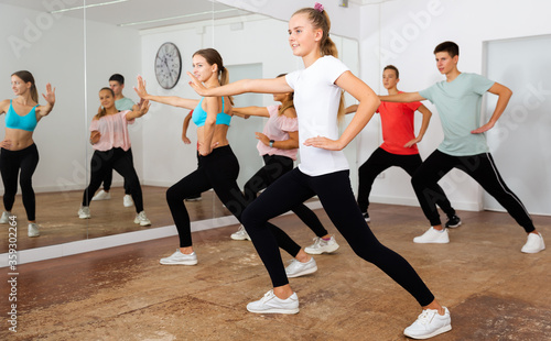 Teenagers participating in dance class with teacher