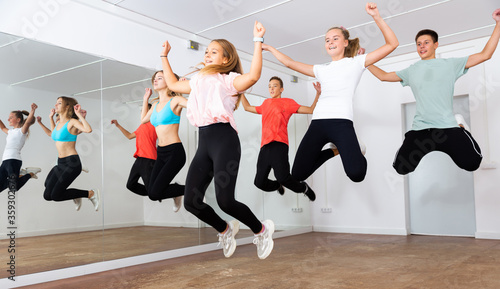 Happy teens jumping in choreography class