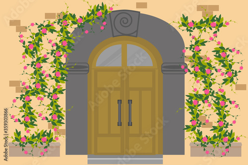 Old wooden door to stone house. Door is large in Mediterranean style. Antique metal handles, decor with an arch, climbing roses branching on wall. Vector illustration in flat style.