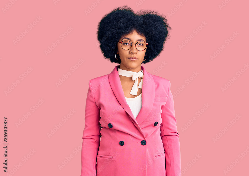 Young african american girl wearing business clothes and glasses with serious expression on face. simple and natural looking at the camera. Young african american girl wearing business clothes and glasses with serious expression on face. simple and natural looking at the camera.