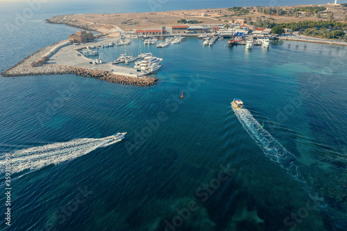 Aerial view of Paphos in Cyprus. Bay with boats and historic fortress in summer.