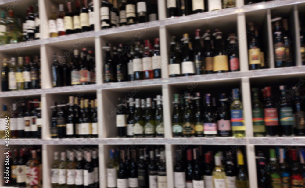 Concept blurred image. Alcohol showcase blurred background. Blurred abstract background of shelf in supermarket