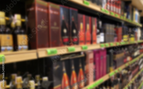 Blurred abstract background of shelf in supermarket. Alcohol showcase blurred background. © Dzmitry