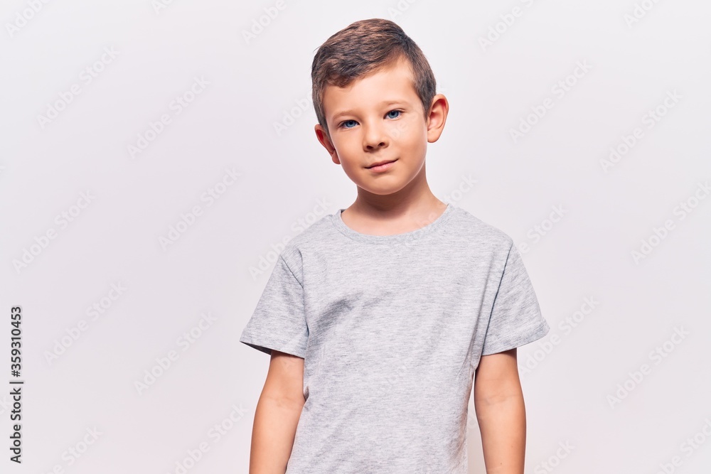 Cute blond kid wearing casual clothes with serious expression on face. simple and natural looking at the camera. Cute blond kid wearing casual clothes with serious expression on face. simple and natural looking at the camera.