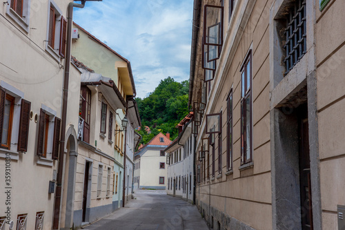 narrow street in the old town of Ljubljana against the backdrop of the fortress © Eugene